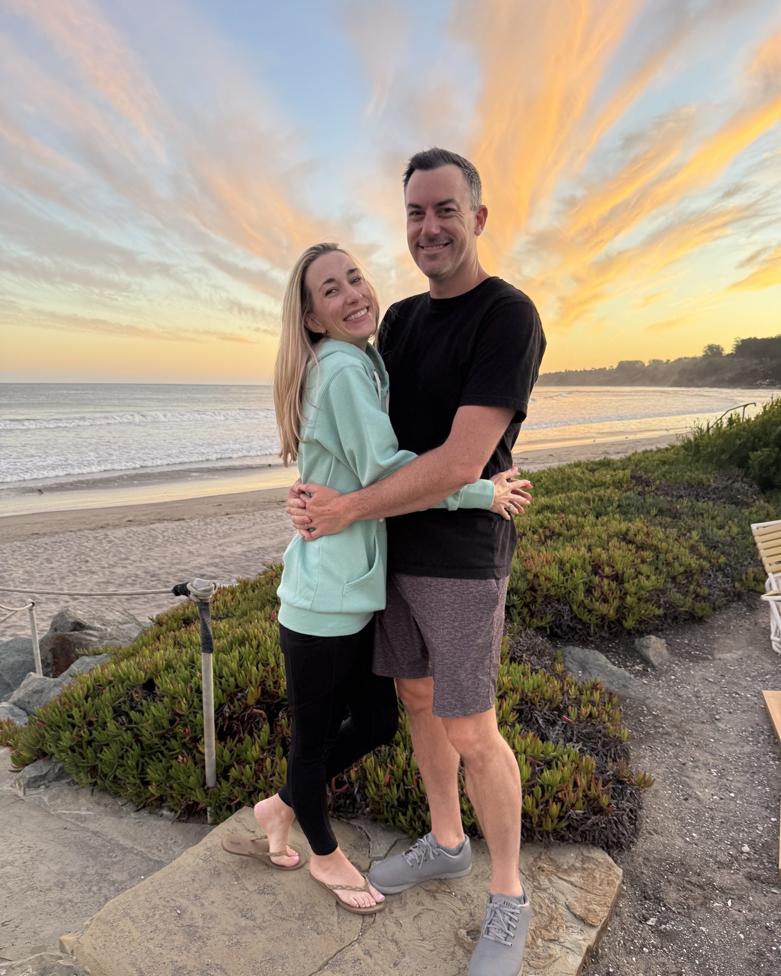 Brian and Allison Skinner on the beach at sunset